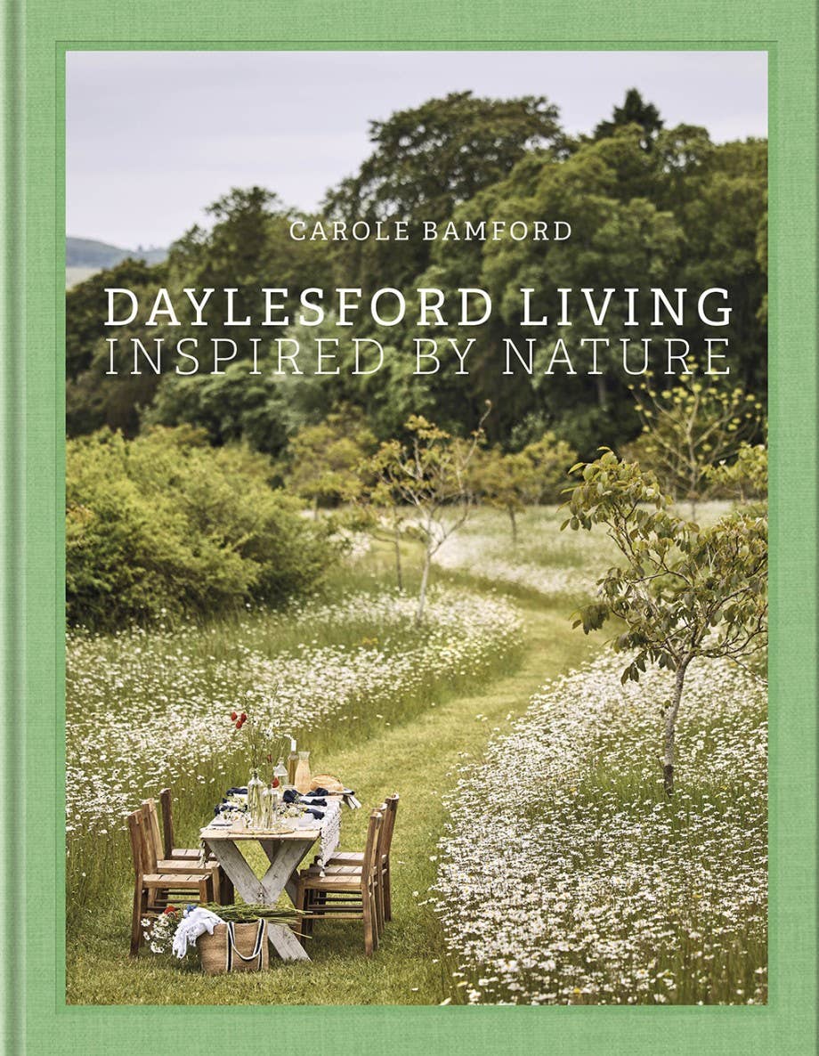 Book cover of 'Daylesford Living: Inspired by Nature' with a scenic landscape and table setting.
