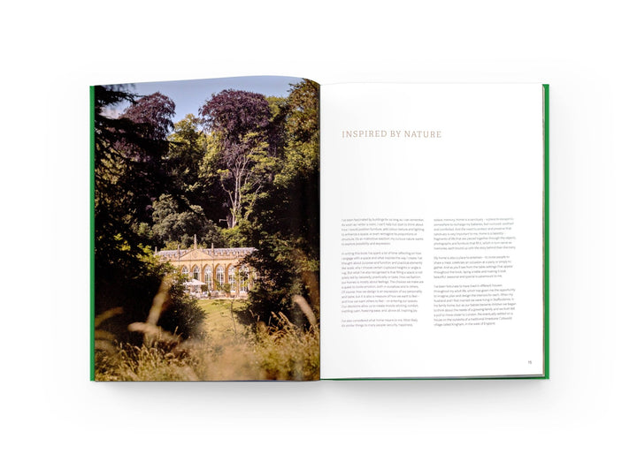 Open book showing a scenic landscape with trees and a building, titled &