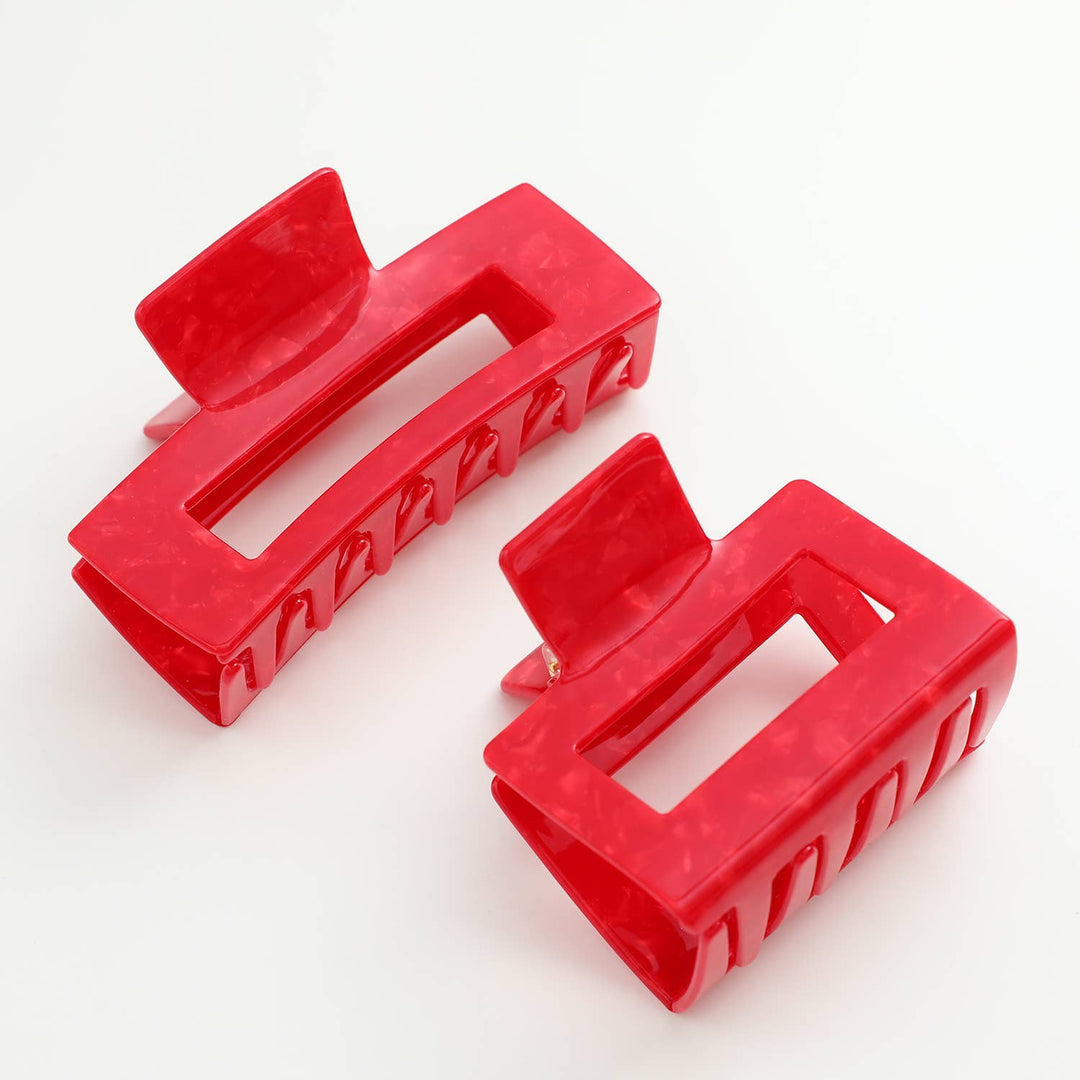 Two red hair clips on a white background