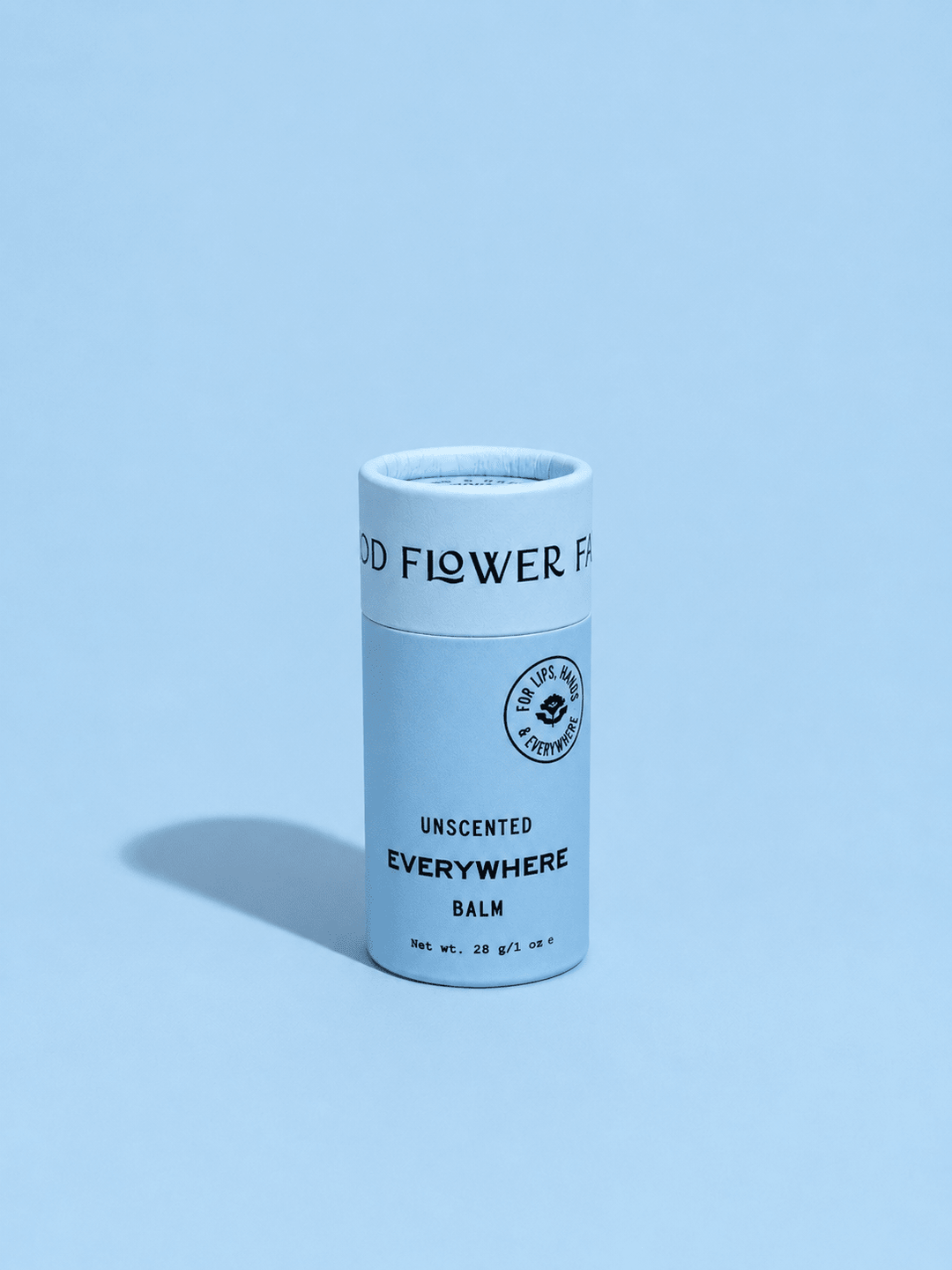 Blue cylindrical balm container with &