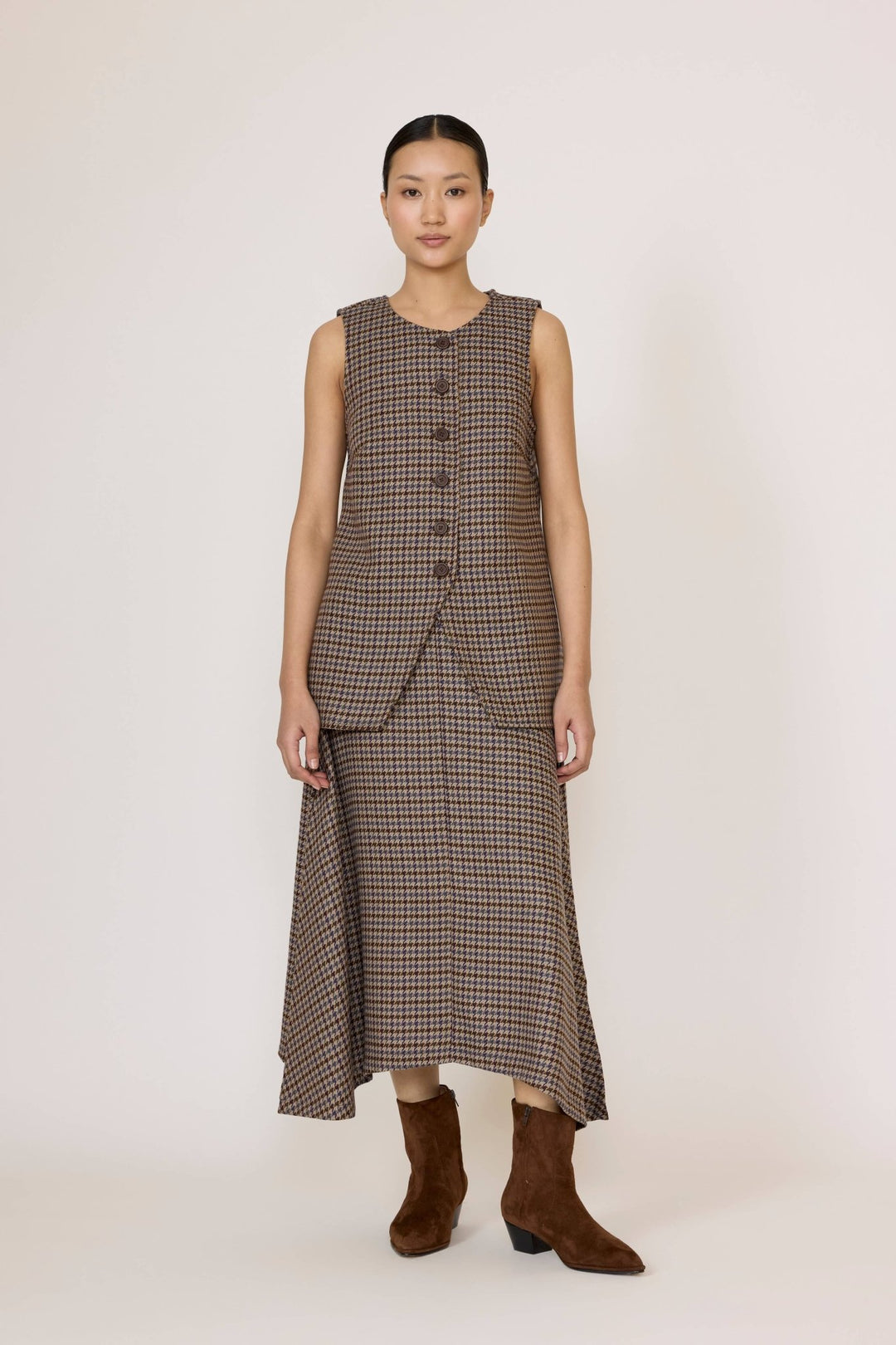 Woman wearing a sleeveless checkered vest with the Flowy Midi Skirt in Wool Plaid on a white background