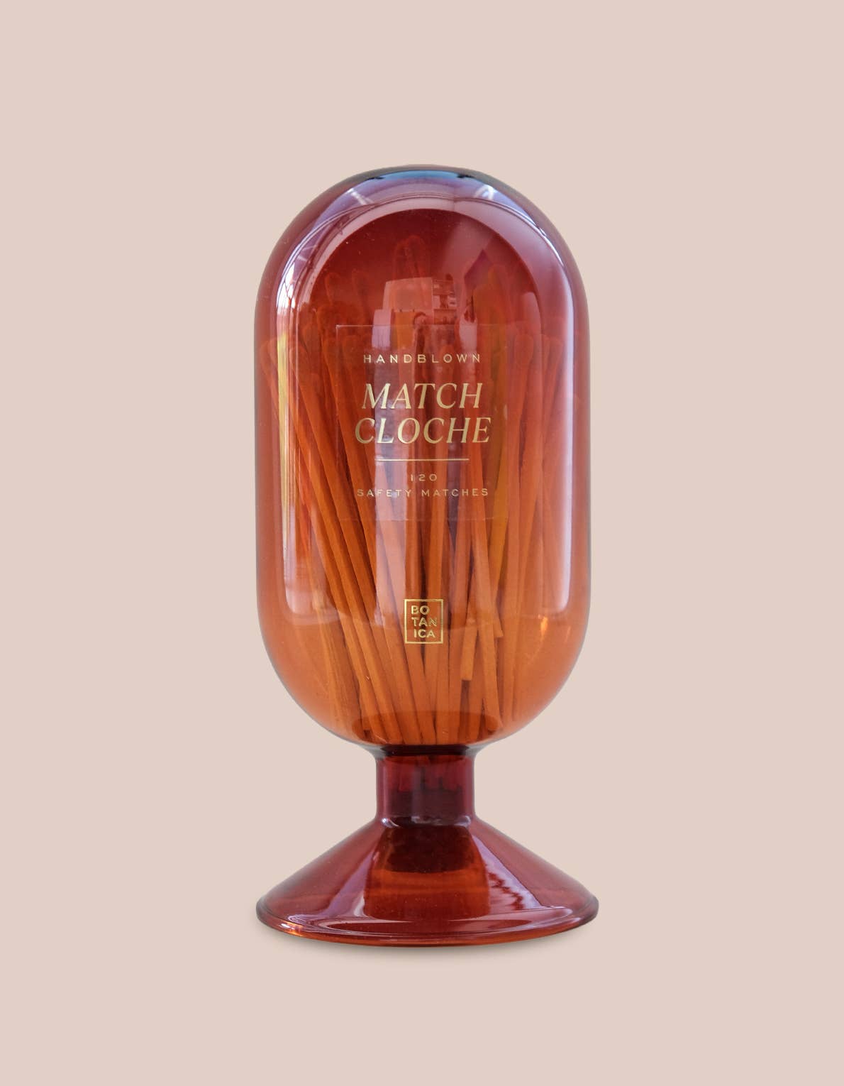 Match Cloche container with wooden matches on a beige background
