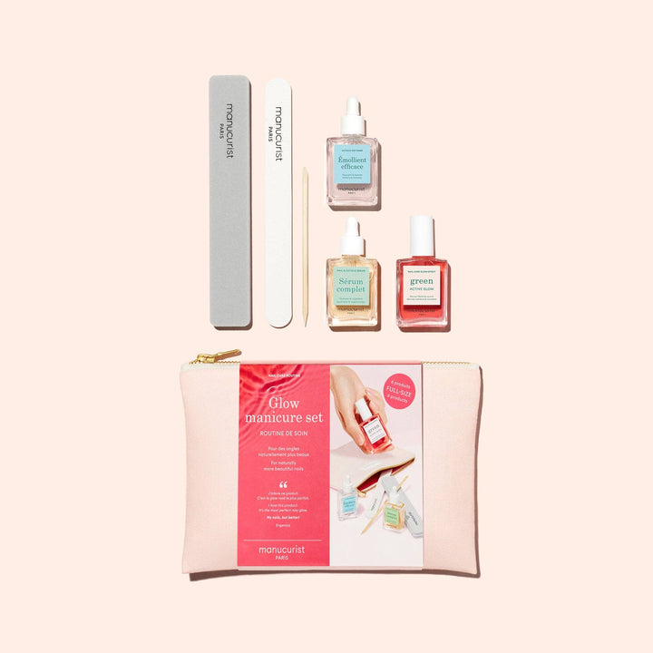 Manicure set with nail polish bottles, a file, and a pouch on a beige background