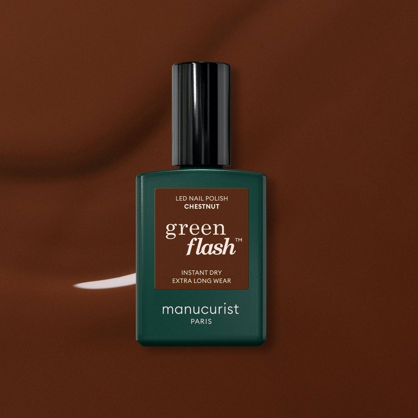 Green Flash nail polish bottle on a brown background