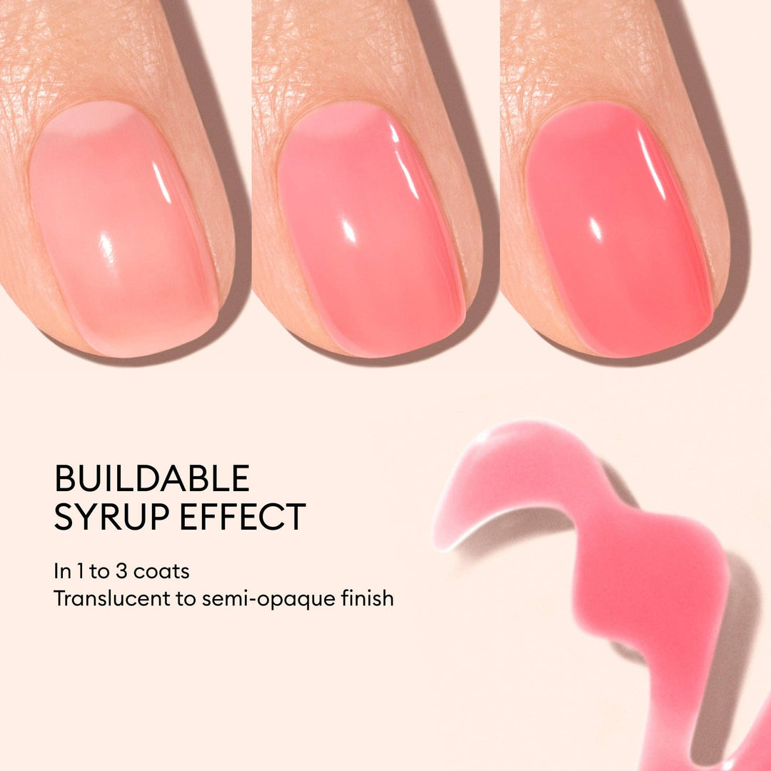 Close-up of pink nail polish on nails with text describing the buildable syrup effect.