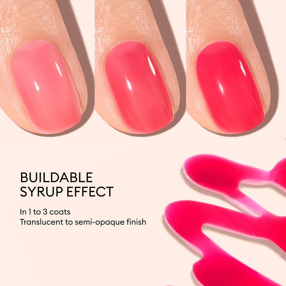 Close-up of pink nail polish with a syrupy effect on nails and a droplet of polish.