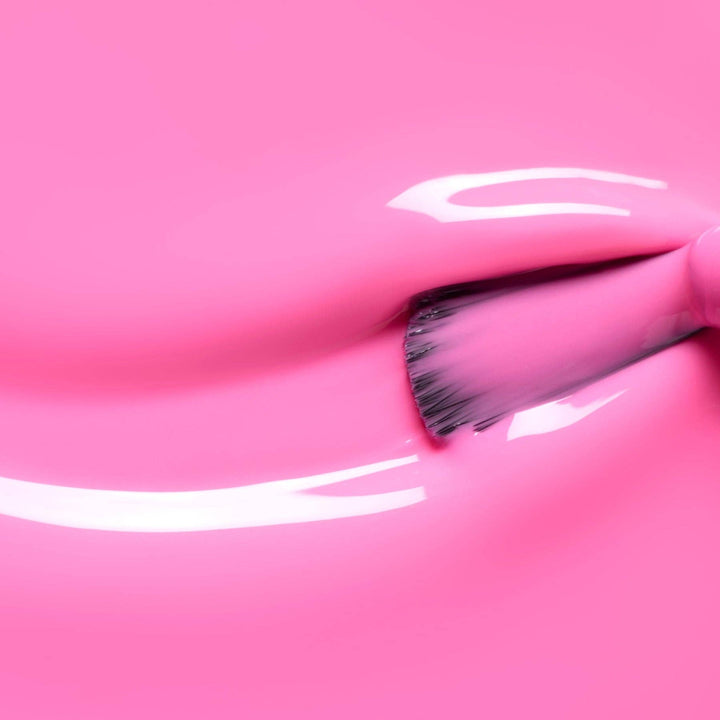 Close-up of a brush with pink nail polish