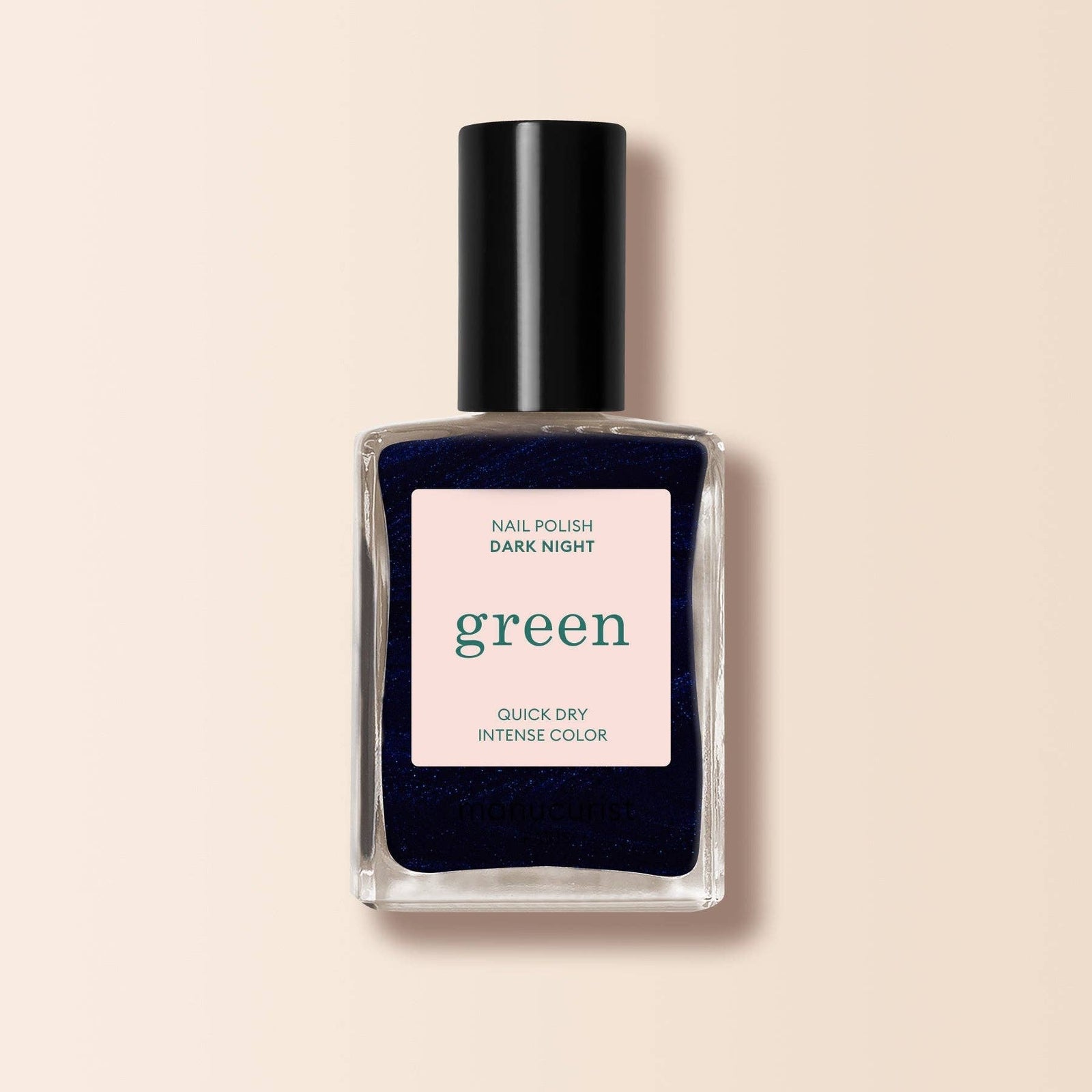 Nail polish bottle labeled 'Dark Night Green' on a beige background