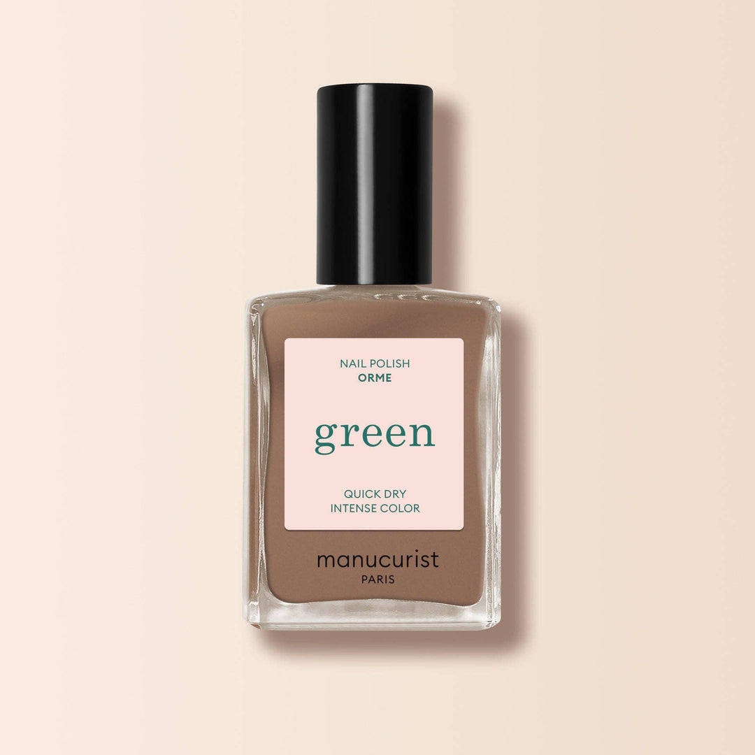 Manucurist nail polish bottle with a on a beige background