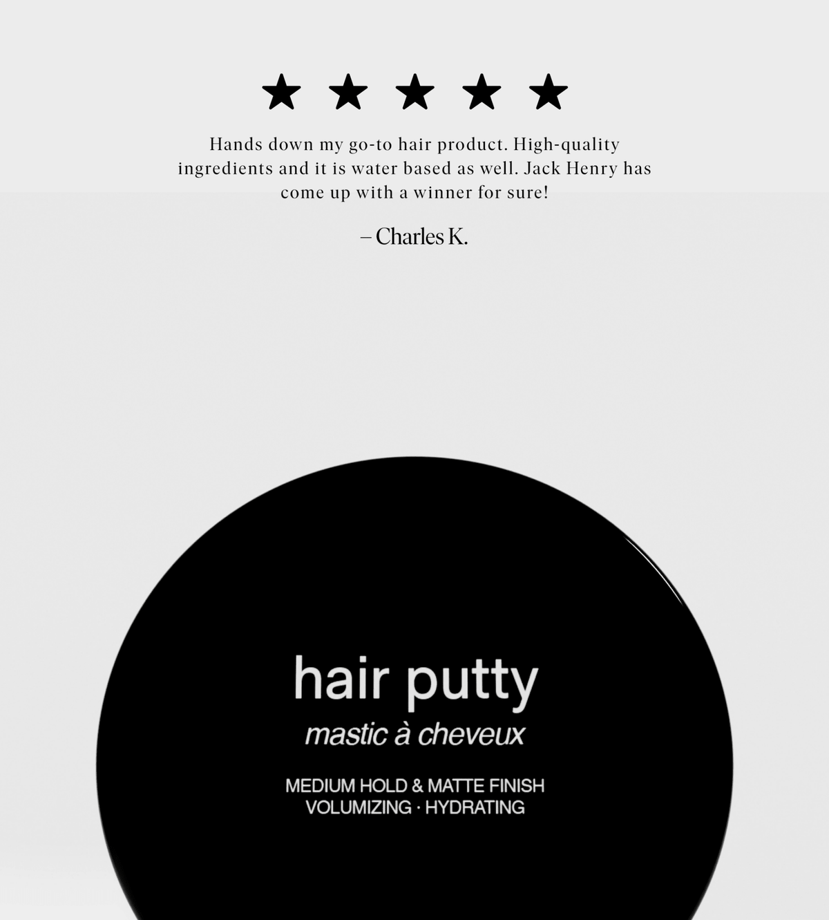 Black hair putty container with white text on a light gray background
