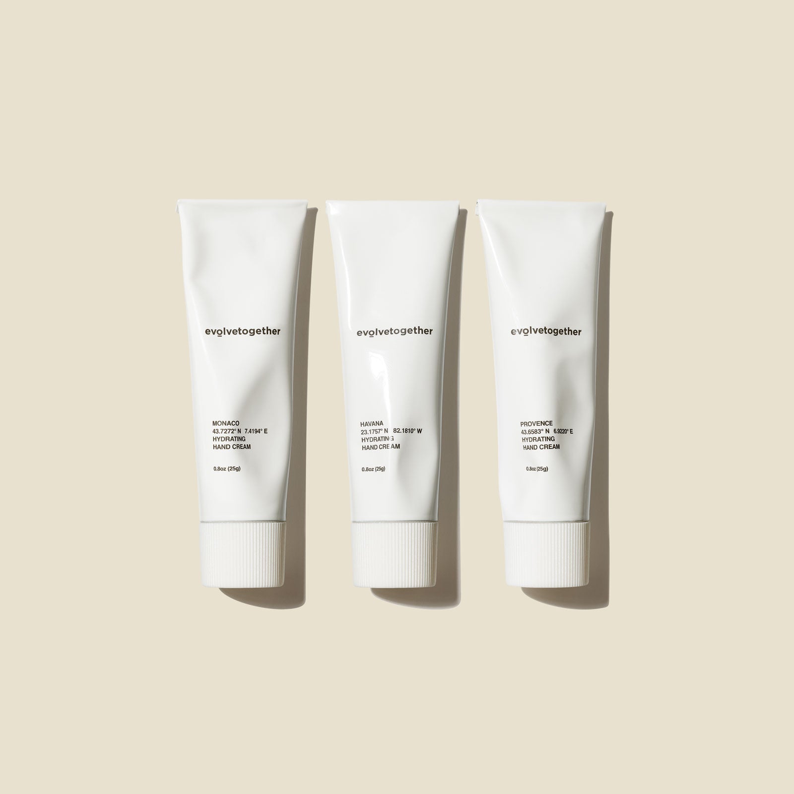 Three white tubes of 'evergether' hand cream on a beige background