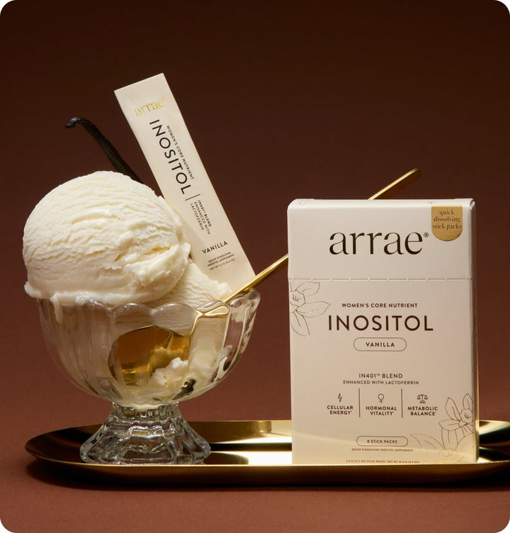 Arrae Inositol supplement box with vanilla ice cream and a vanilla bean on a brown background