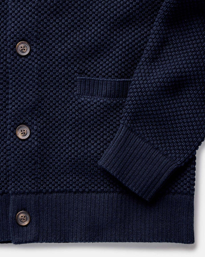 The Crawford Sweater in Navy with buttons on a white background