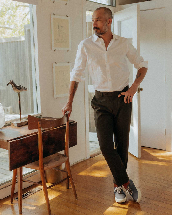 man wearing white dress shirt with black dress pants and shoes. 