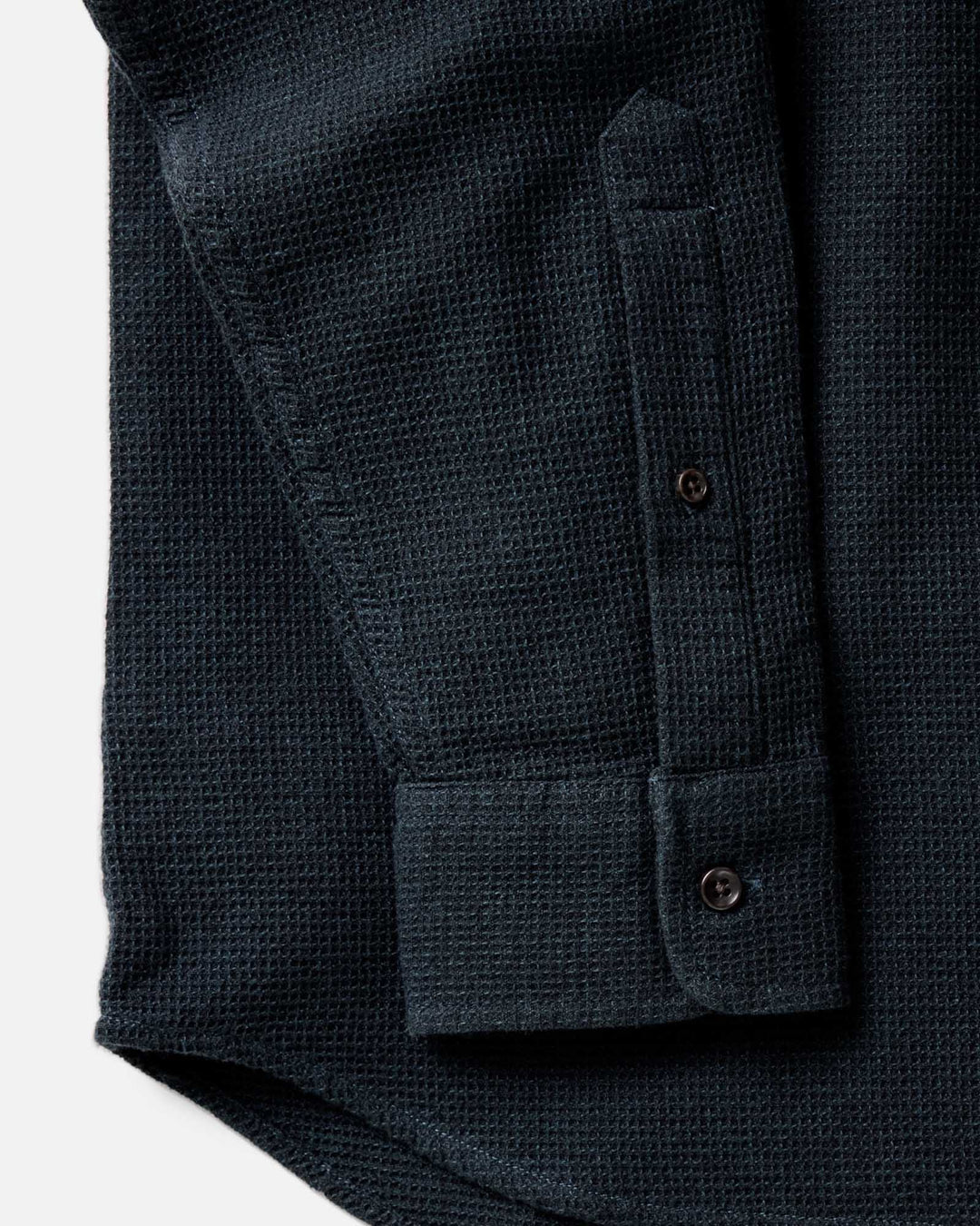Close-up of The Jack Shirt in Forest Waffle, showing a textured long-sleeve and the sleeve cuff with button tabs and part of the button placket.