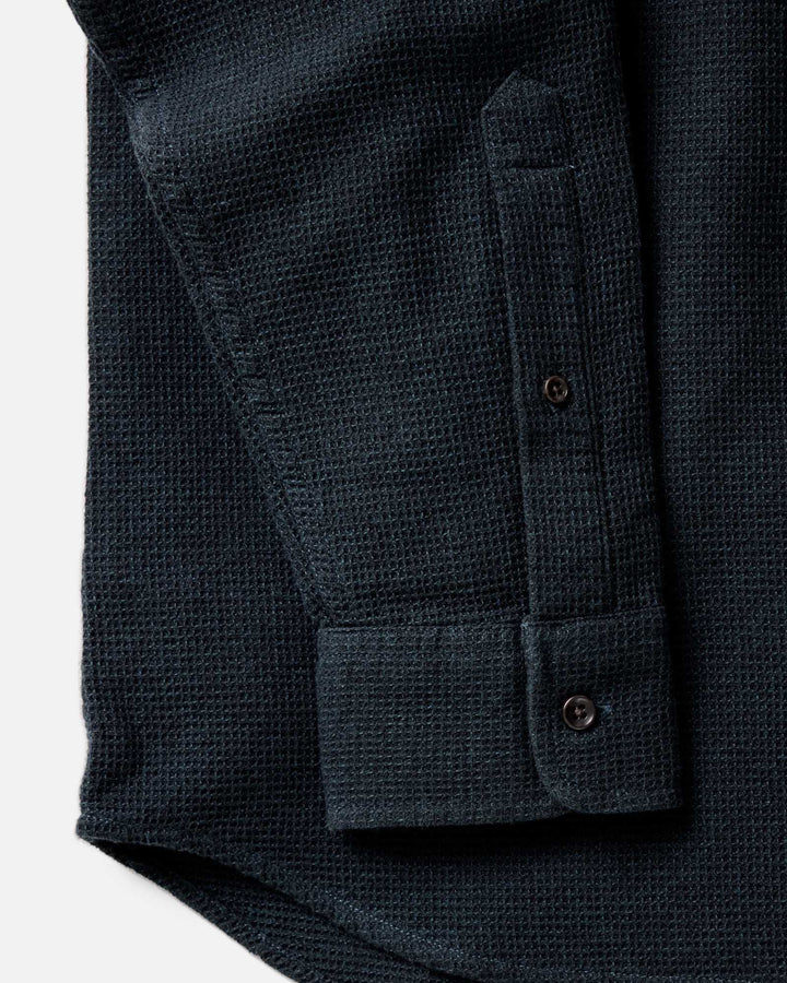 Close-up of The Jack Shirt in Forest Waffle, showing a textured long-sleeve and the sleeve cuff with button tabs and part of the button placket.