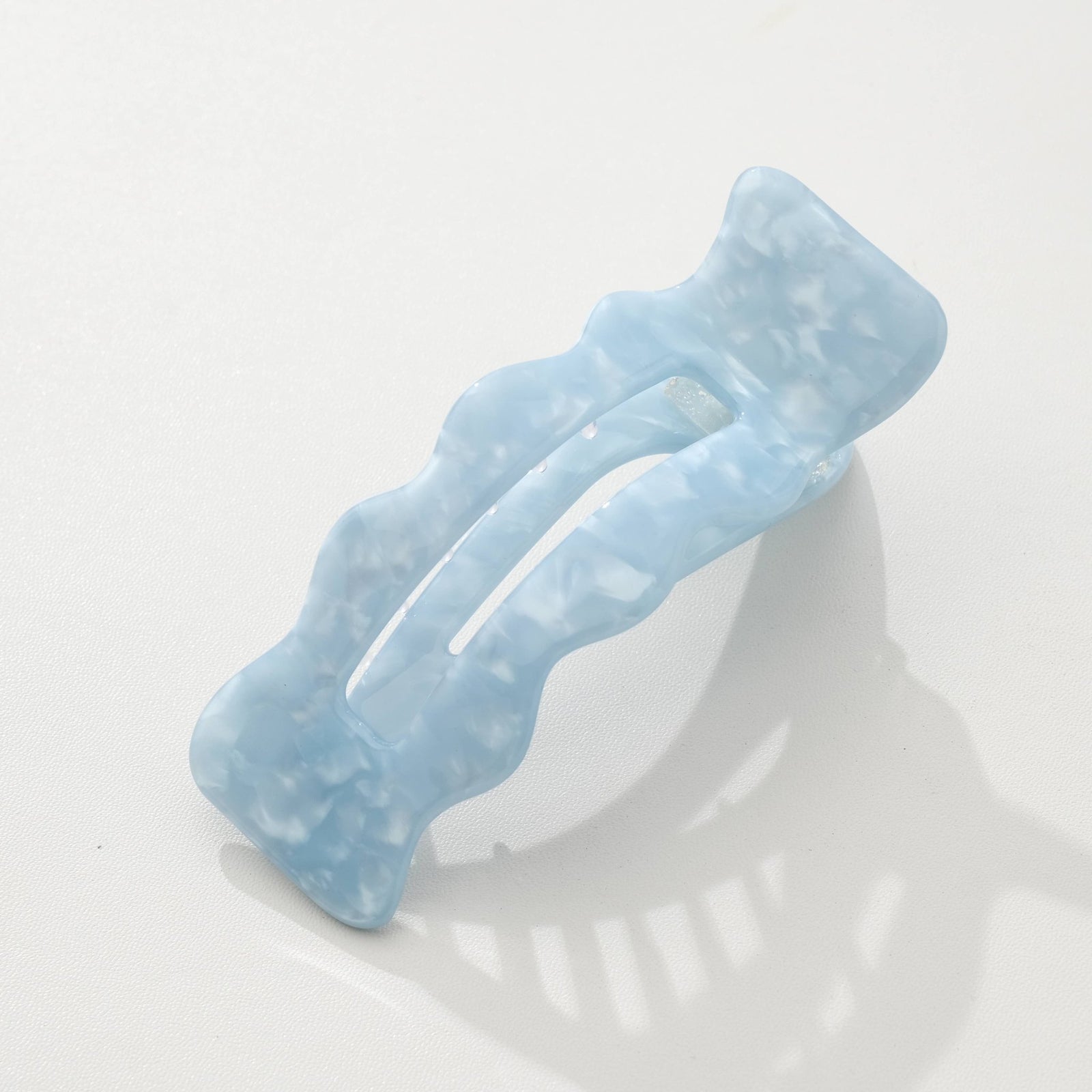 Saltwater blue hair clip on a white background