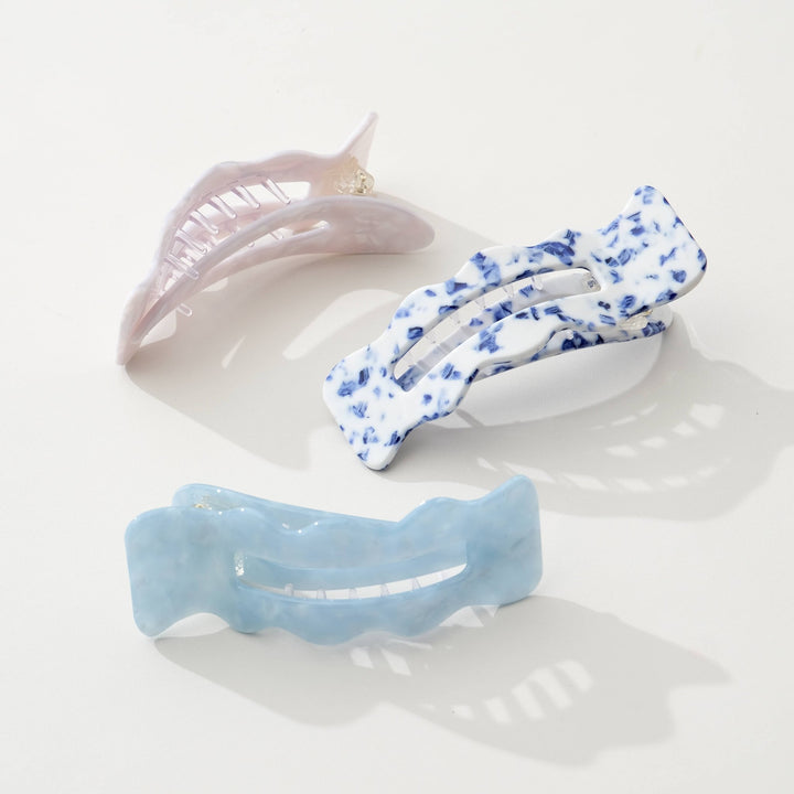 Three Adorro hair clips in Coastal blue, Saltwater Blue, and Ivory on a light background