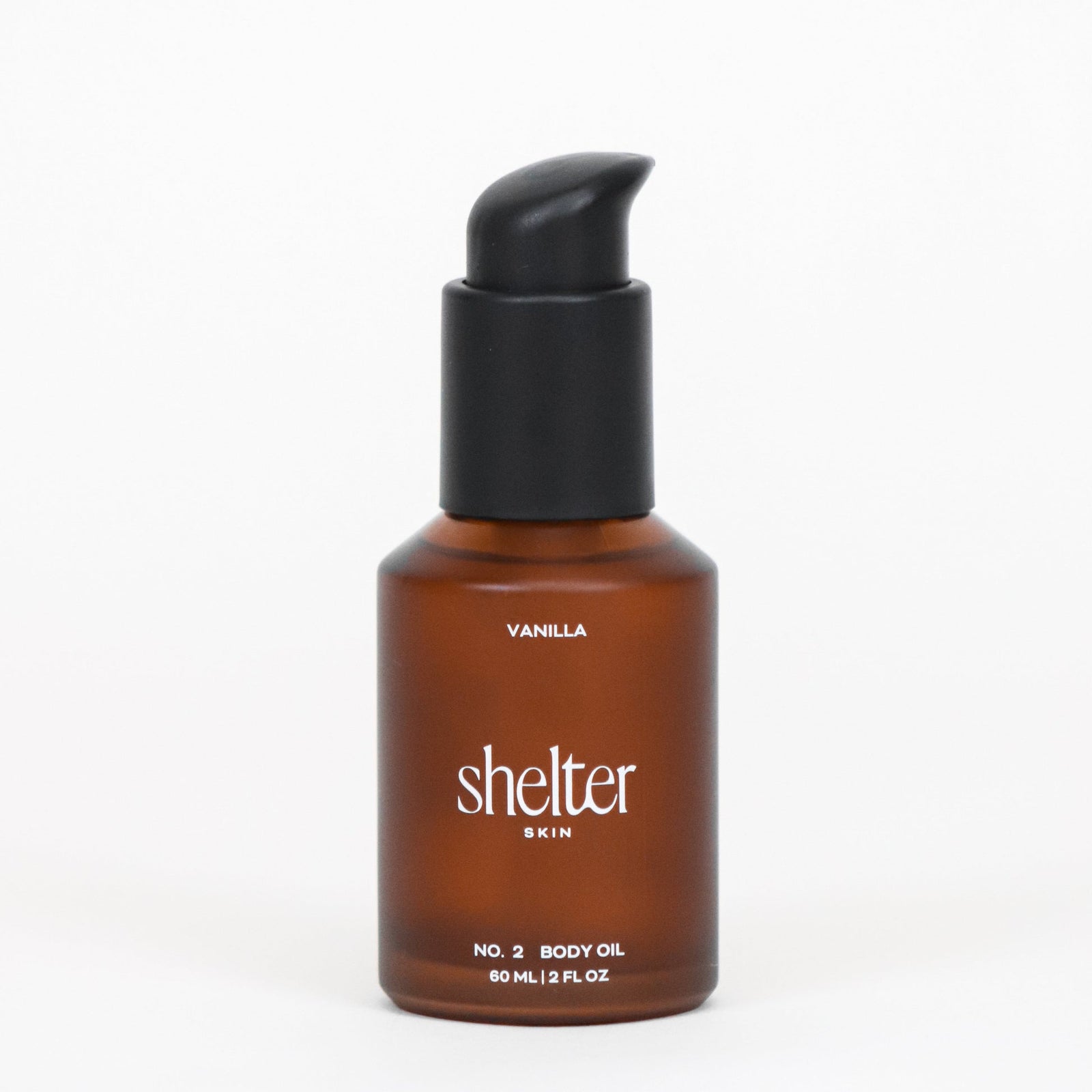 Mini bottle of Shelter Skin's No. 2 Vanilla Body Oil on a white background.