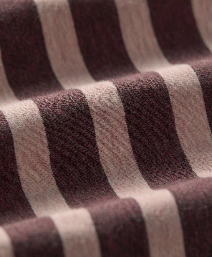 Close-up of a striped knit fabric with alternating wide bands of merlot and clay.