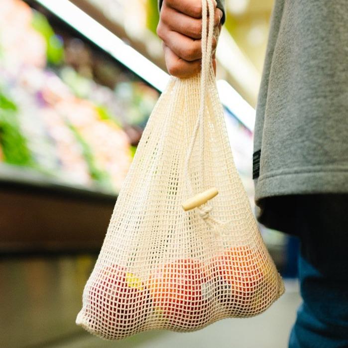 Organic Cotton Mesh Produce Bags - 2 Pack - Displayed filled with apples and being carried through a grocery store - Echo Market