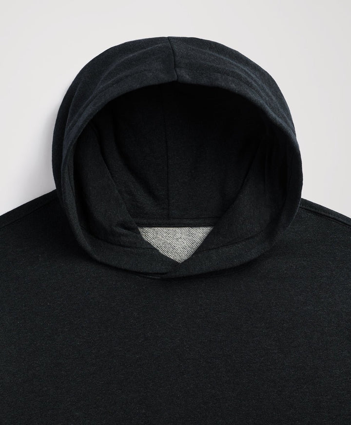 Close-up of a charcoal heather hooded sweatshirt with a contrasting light gray inner lining visible at the opening, shot against a plain light gray background.