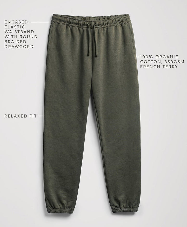 Pact dusted green relaxed-fit sweatpants with a drawstring waistband, shown on a light gray background with text callouts describing features and fabric.