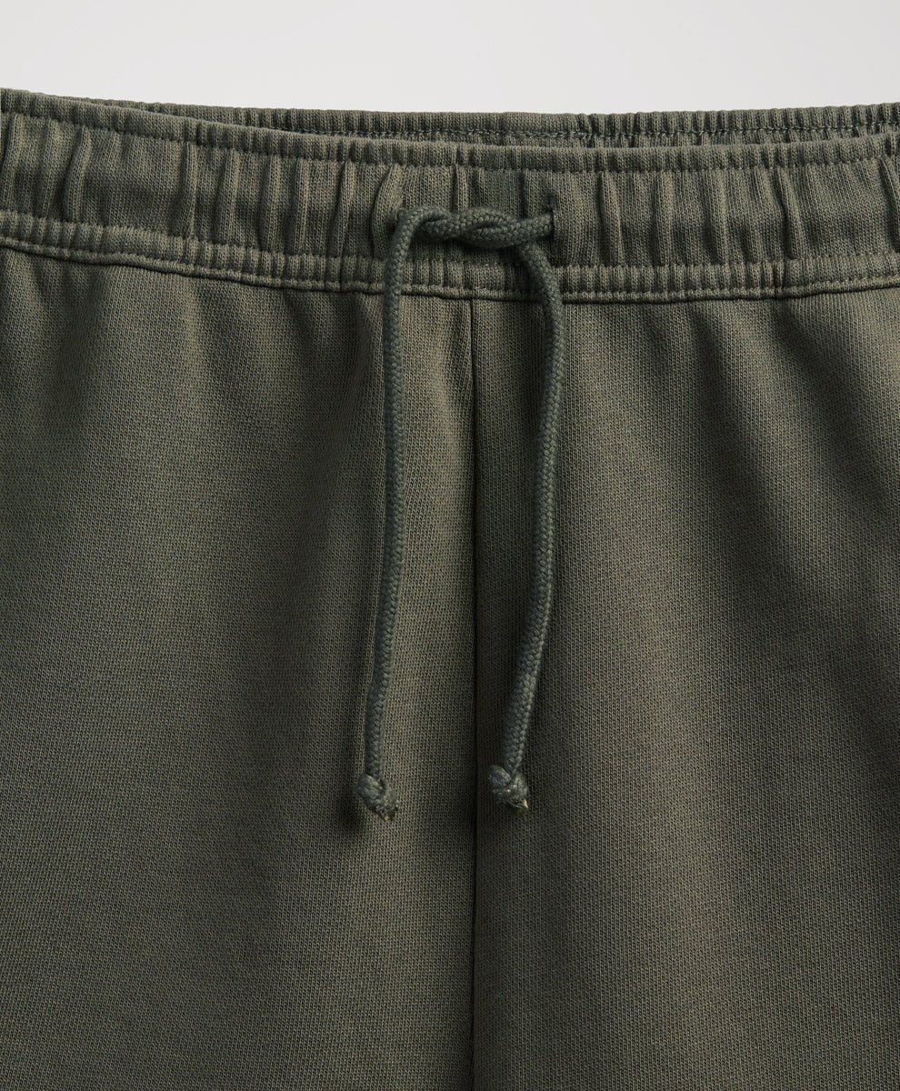 close up of pact dusted green sweatpants elastic waist and drawtring.