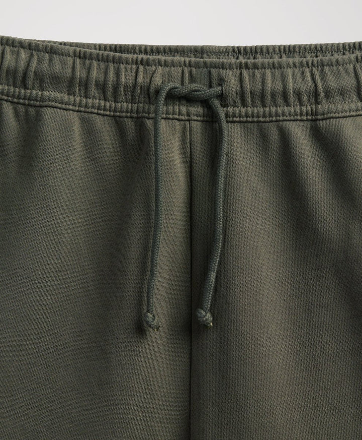 close up of pact dusted green sweatpants elastic waist and drawtring.