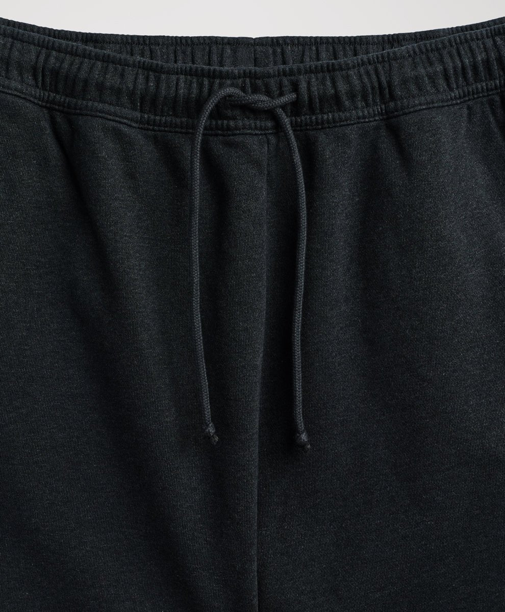 Close-up of pact charcoal heather sweatpants showing the elastic waistband and matching drawstring.