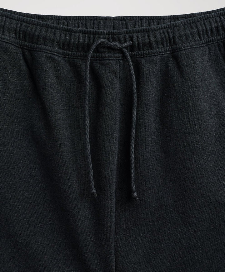 Close-up of pact charcoal heather sweatpants showing the elastic waistband and matching drawstring.