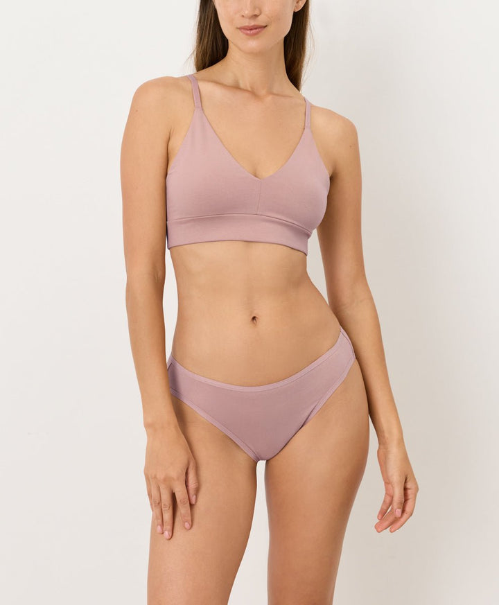 Woman wearing a pink set on a white background