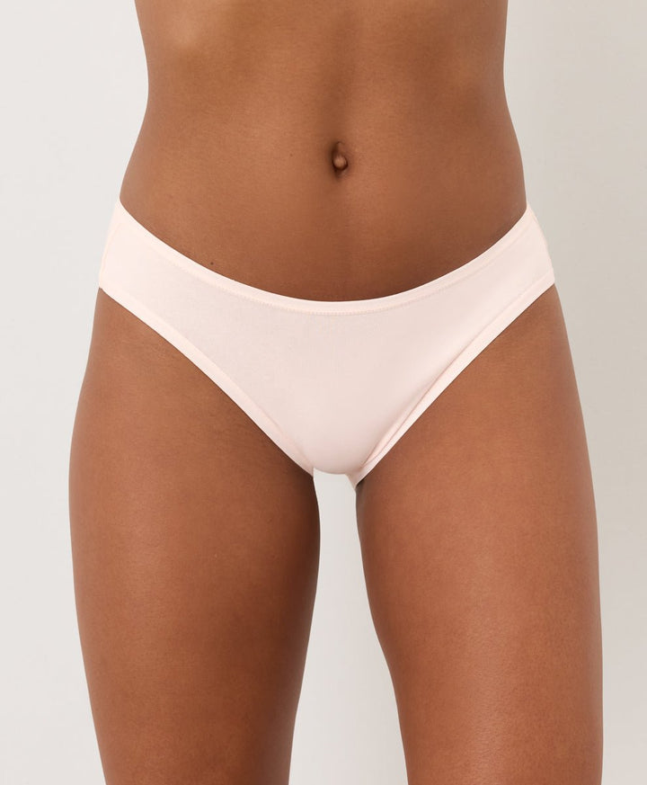 Light Pink underwear worn by a person on a plain background