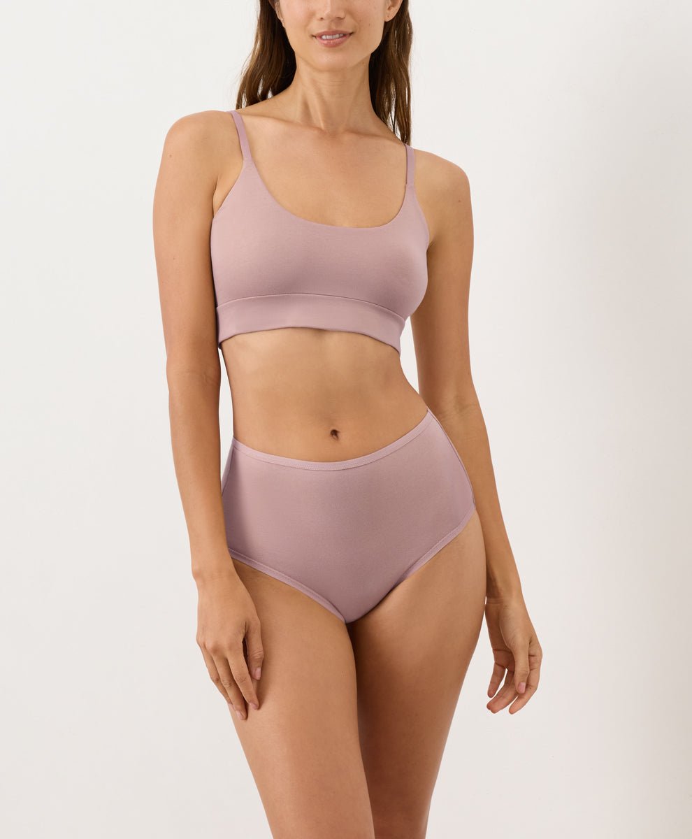 Person wearing mauve high-waisted underwear and T-shirt Bra on a white background