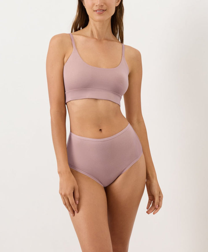 Person wearing mauve high-waisted underwear and T-shirt Bra on a white background
