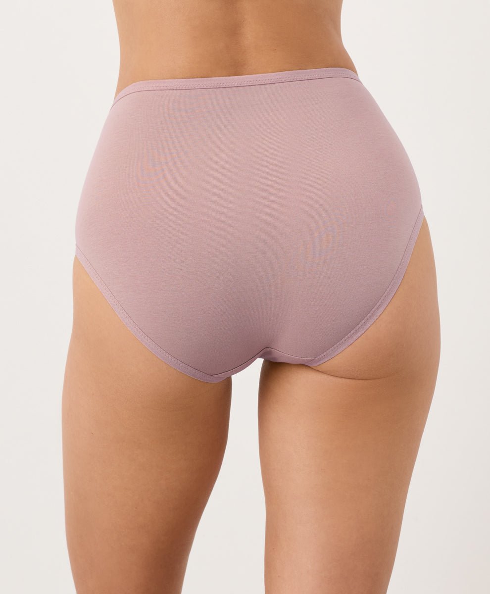 Person wearing mauve high-waisted underwear on a white background