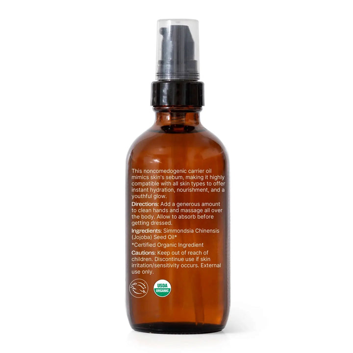 Brown glass bottle with a black spray nozzle on a white background