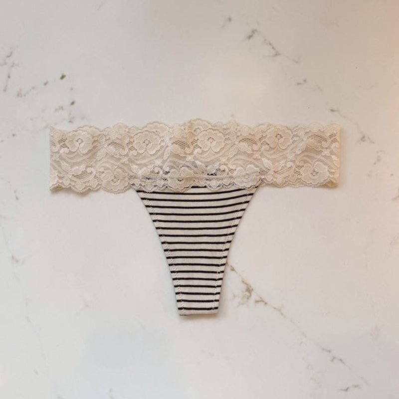 Striped thong with lace top on a marble surface