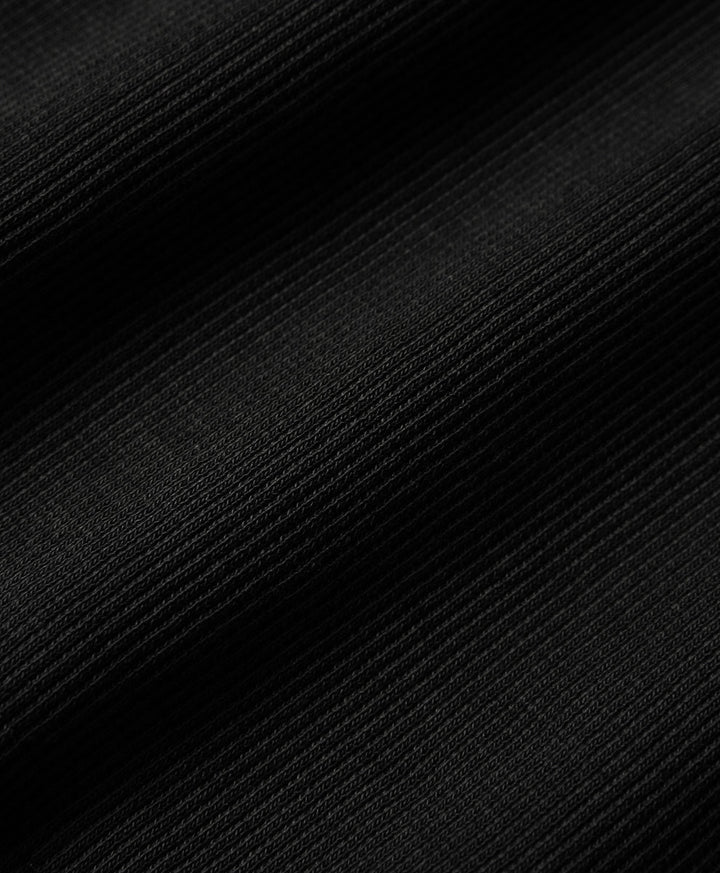 Close-up of black textured rib fabric.