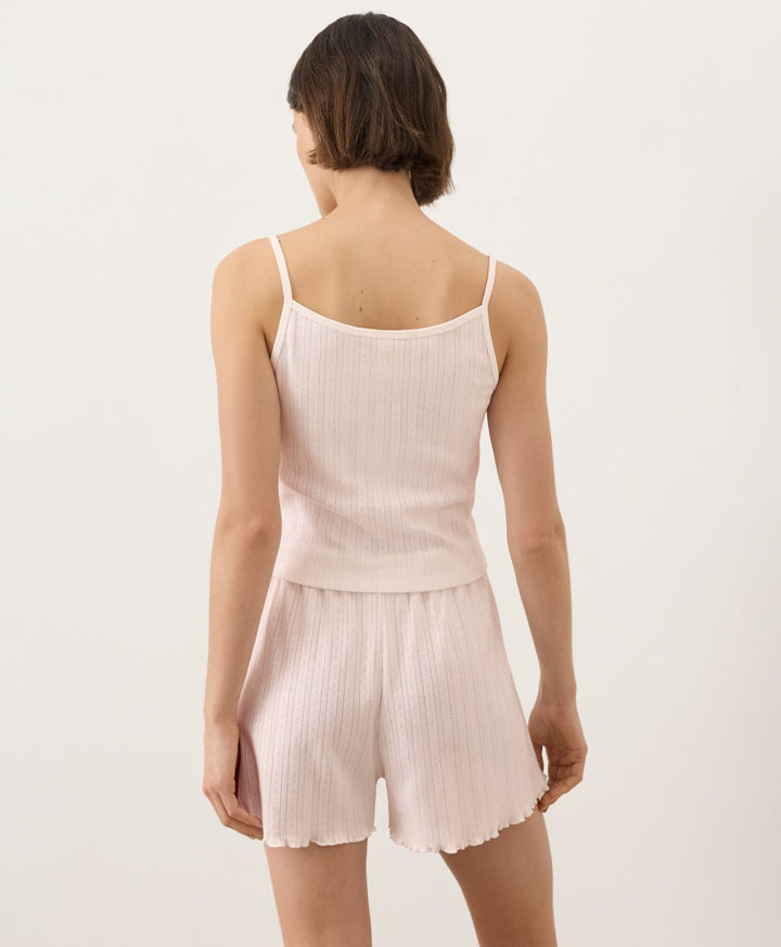 Woman wearing Pact Organic Pointelle Cami and shorts set in soft pink on a white background