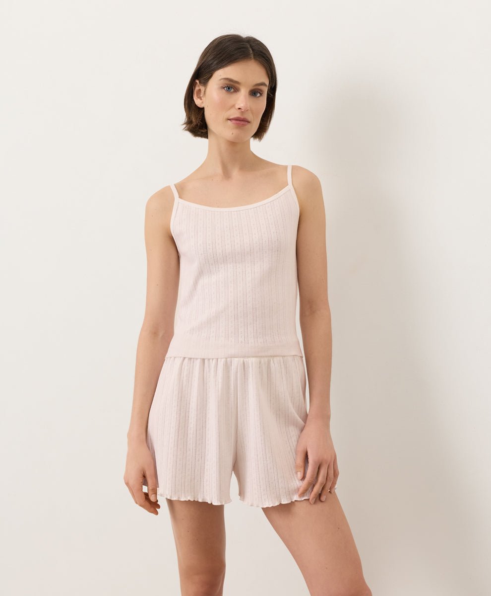 Woman wearing Pact Organic Pointelle Cami and shorts set in Soft Pink on a white background