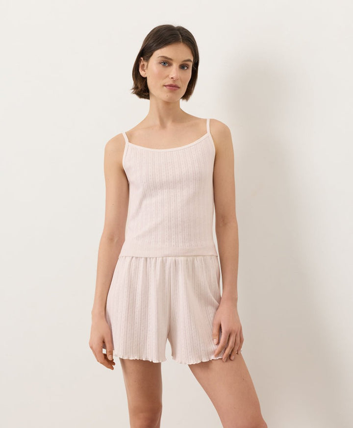 Woman wearing Pact Organic Pointelle Cami and shorts set in Soft Pink on a white background