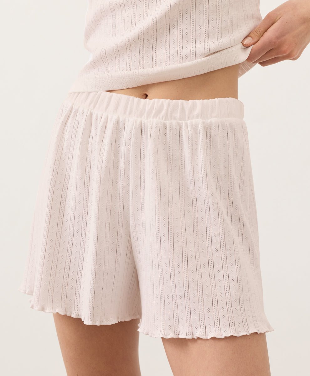 Person wearing soft pink Pact Organic Pointelle Shorts on a plain background