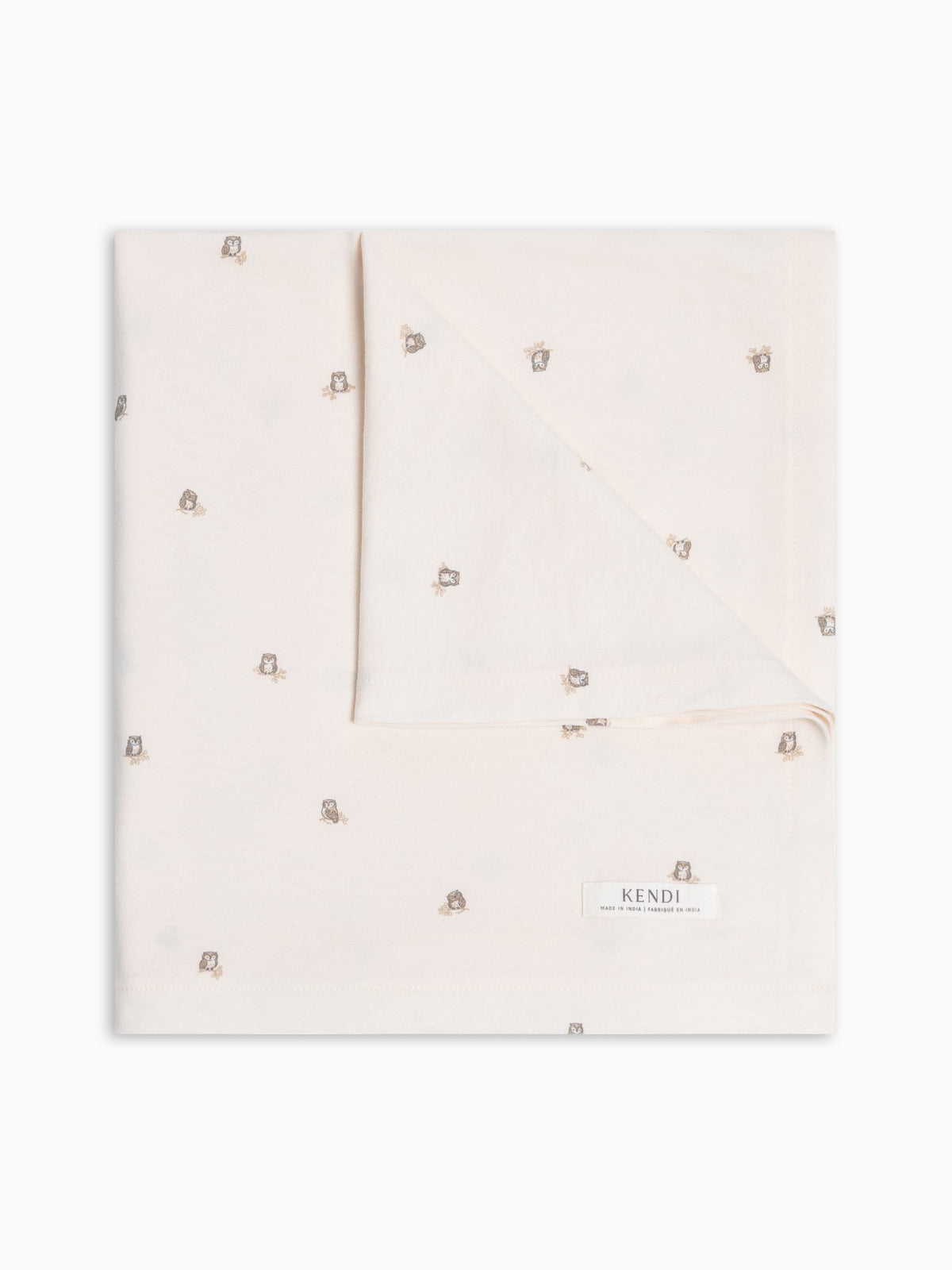A folded colored organics' swaddle with owl print on a white background.