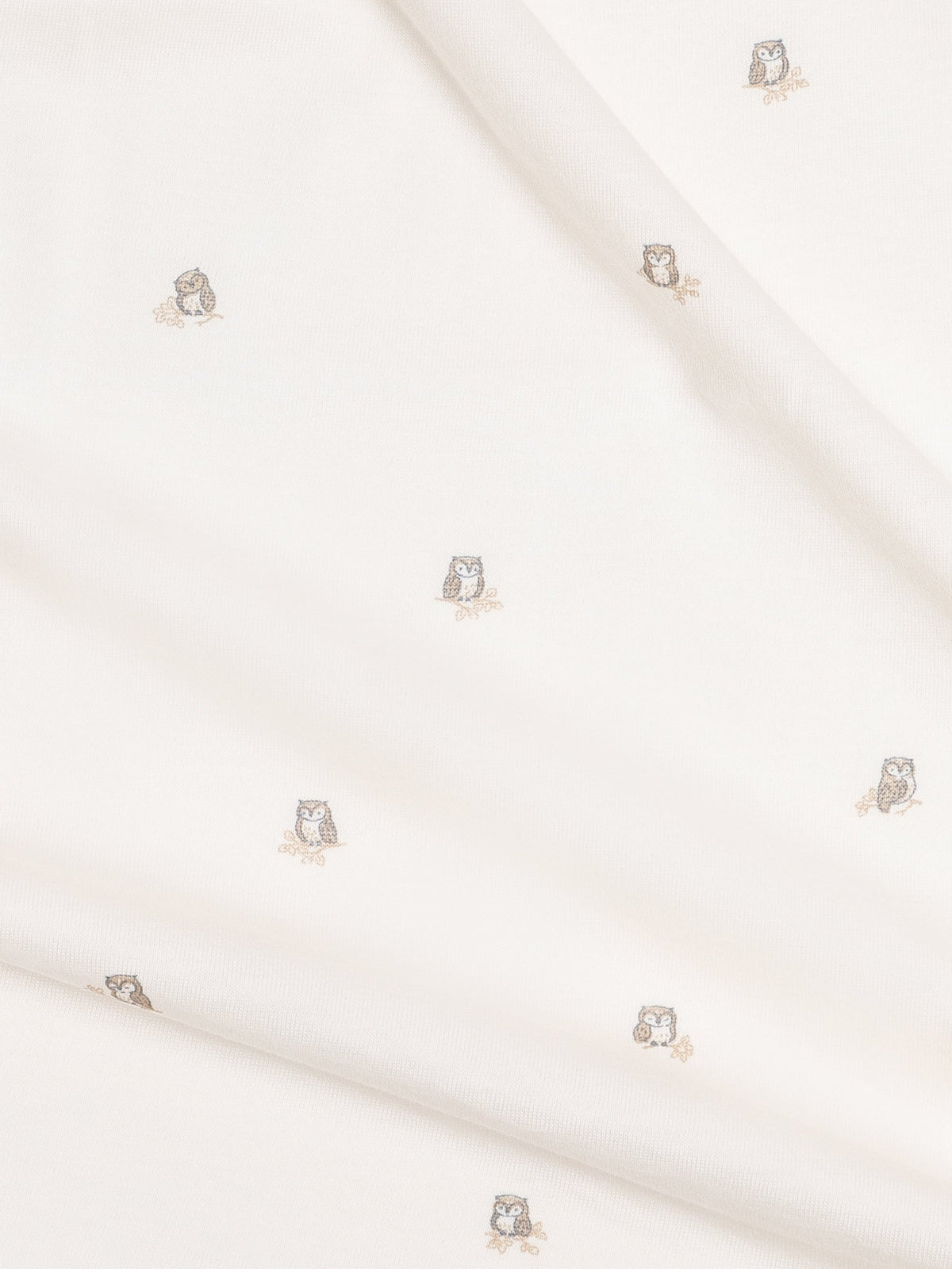 A close up of colored organics swaddle blanket in owl print 