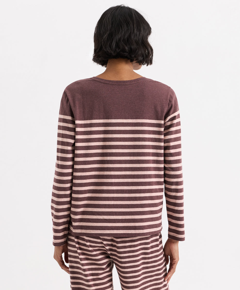 A model shown from the back wearing a long-sleeve crewneck top and matching striped pants in merlot and clay colorway, set against a plain light gray background.