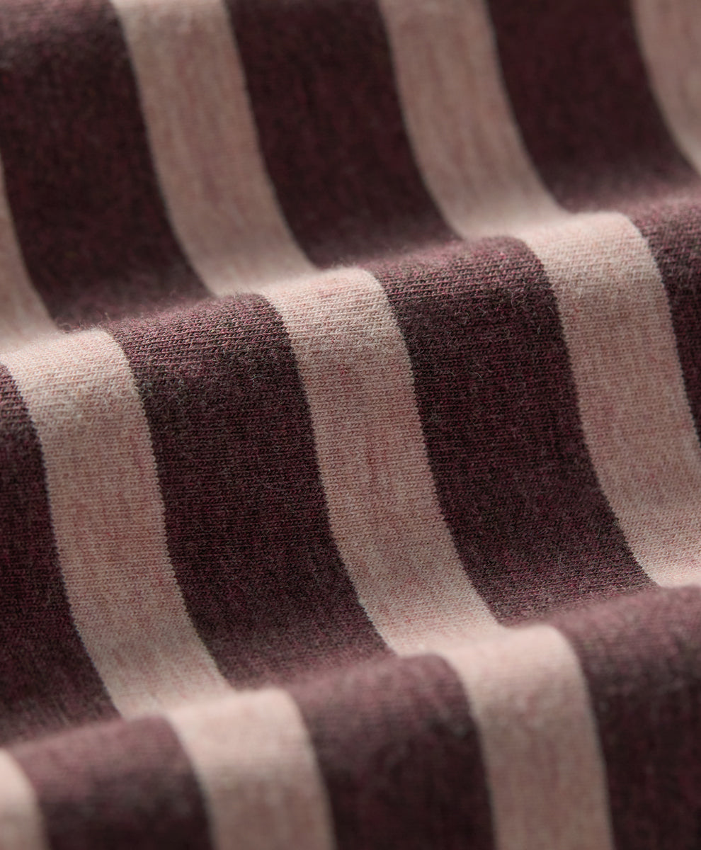 Close-up of a striped knit fabric with alternating wide bands of merlot and clay.