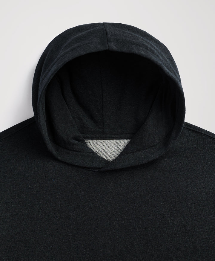 Close-up of a charcoal heather hooded sweatshirt with a contrasting light gray inner lining visible at the opening, shot against a plain light gray background.