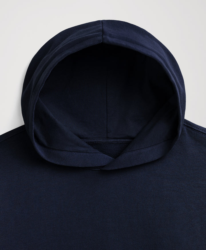 Close-up of a dark navy blue hooded sweatshirt showing the interior of the hood and upper chest area against a light gray background.