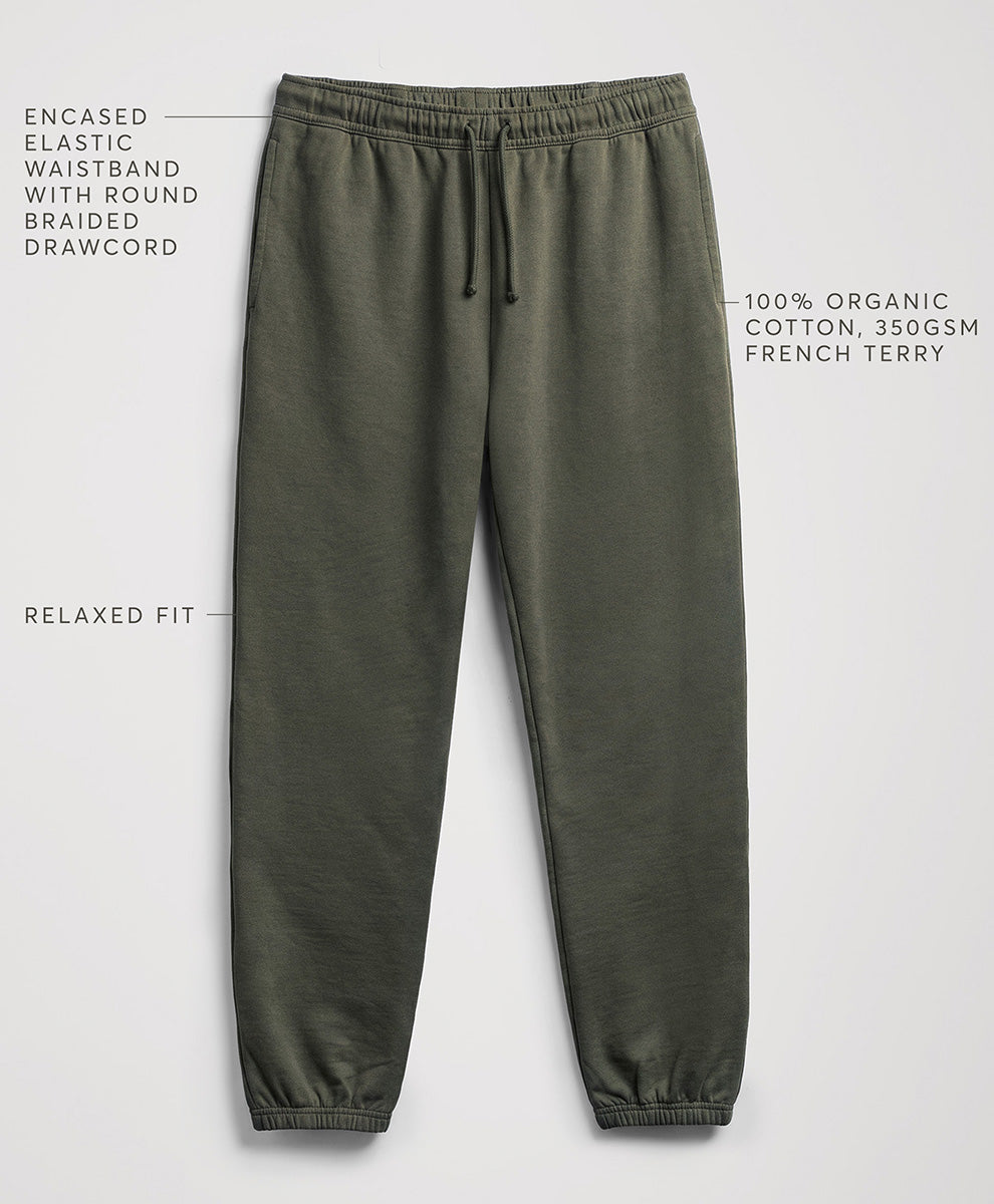 Pact dusted green relaxed-fit sweatpants with a drawstring waistband, shown on a light gray background with text callouts describing features and fabric.